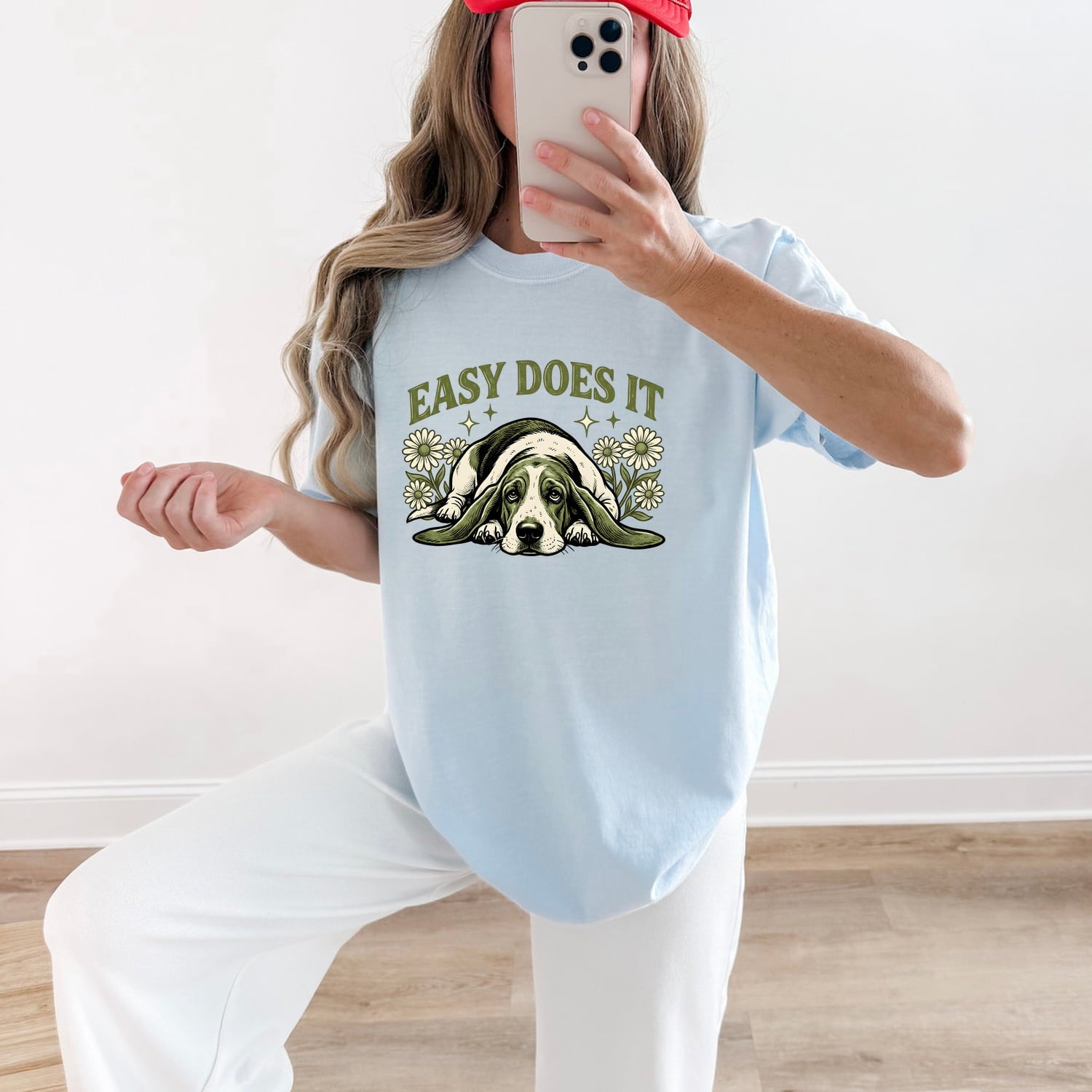 Woman wearing a chambray Comfort Colors 1717 t-shirt with a dog graphic and 'Easy Does It' text, taking a mirror selfie.