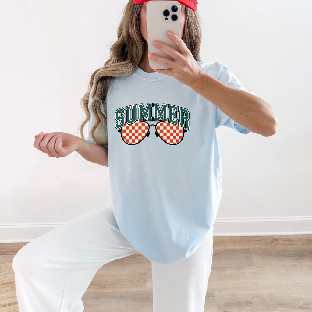 Woman wearing a chambray Comfort Colors 1717 t-shirt with 'Summer' and sunglasses graphic, taking a mirror selfie.