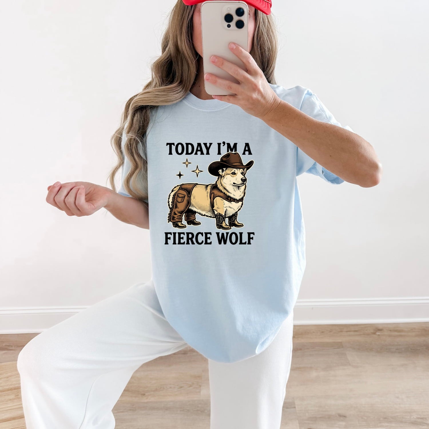 Woman wearing a Chambray Comfort Colors 1717 t-shirt with a corgi graphic and funny text, taking a mirror selfie.