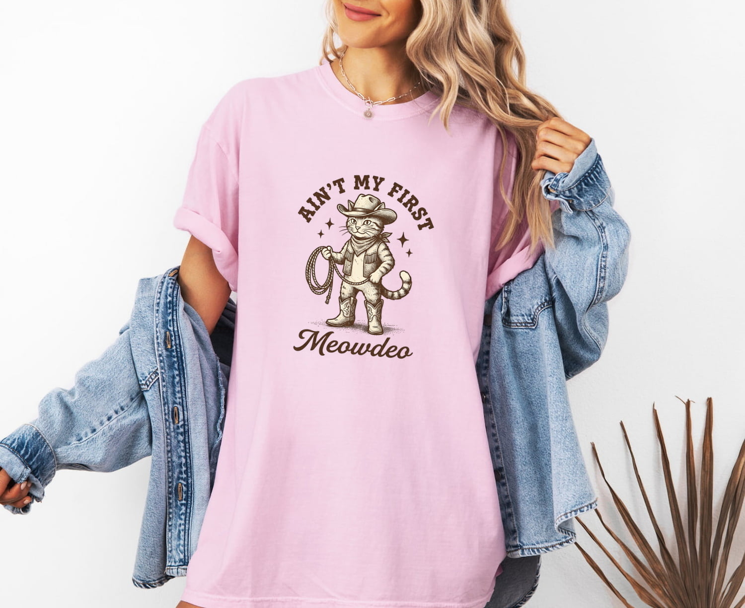Woman wearing a Blossom Comfort Colors 1717 t-shirt with a funny cat graphic and text, standing against a white background.