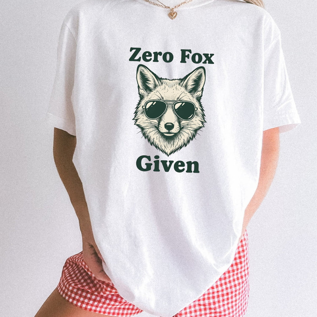 Woman wearing white Comfort Colors 1717 t-shirt with a fox graphic and text 'Zero Fox Given' on a plain background