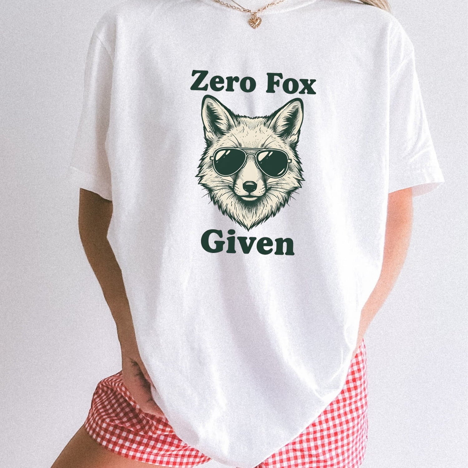 Woman wearing white Comfort Colors 1717 t-shirt with a fox graphic and text 'Zero Fox Given' on a plain background