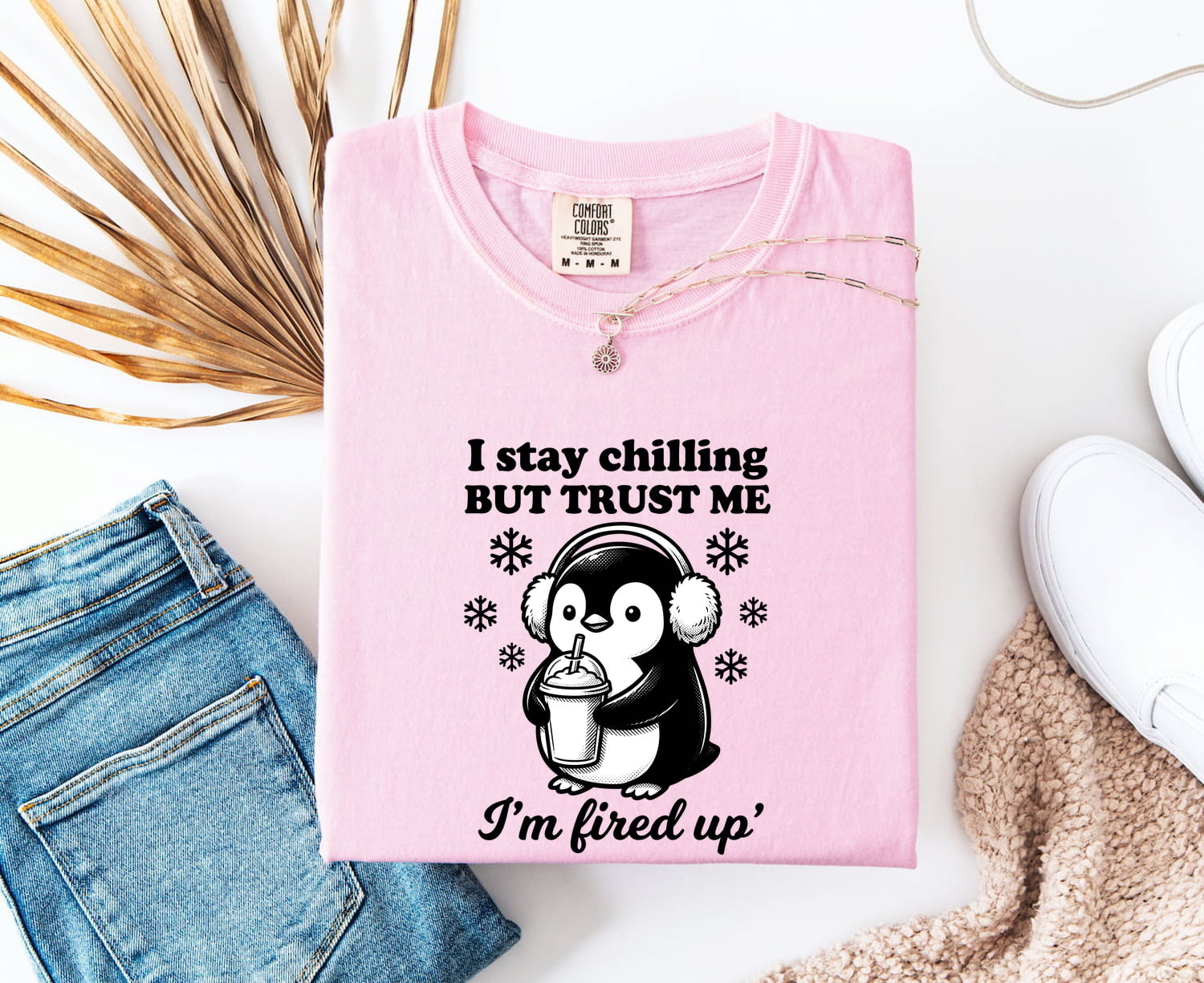 Blossom Comfort Colors 1717 t-shirt with a penguin graphic and funny text on a white surface with jeans and a shoe.